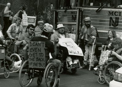 “I can’t even get to the back of the bus.” ADAPT activists protesting for accessible transportation, Philadelphia, 1990. [Smithsonian National Museum of American History]