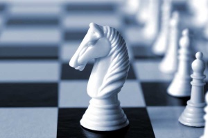 White knight on a chess board.  Shallow depth of field, blue duotone.
